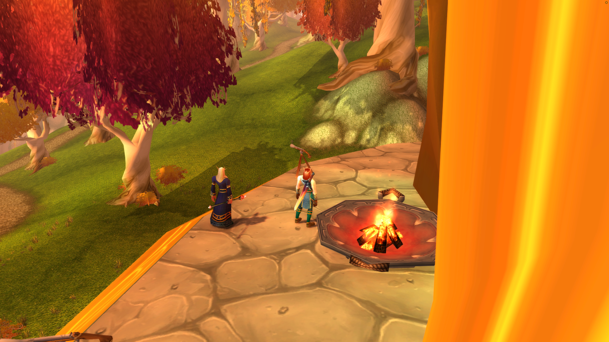A blood elf and a robed magister stand beside a burning brazier and telescope overlooking orange and red trees.