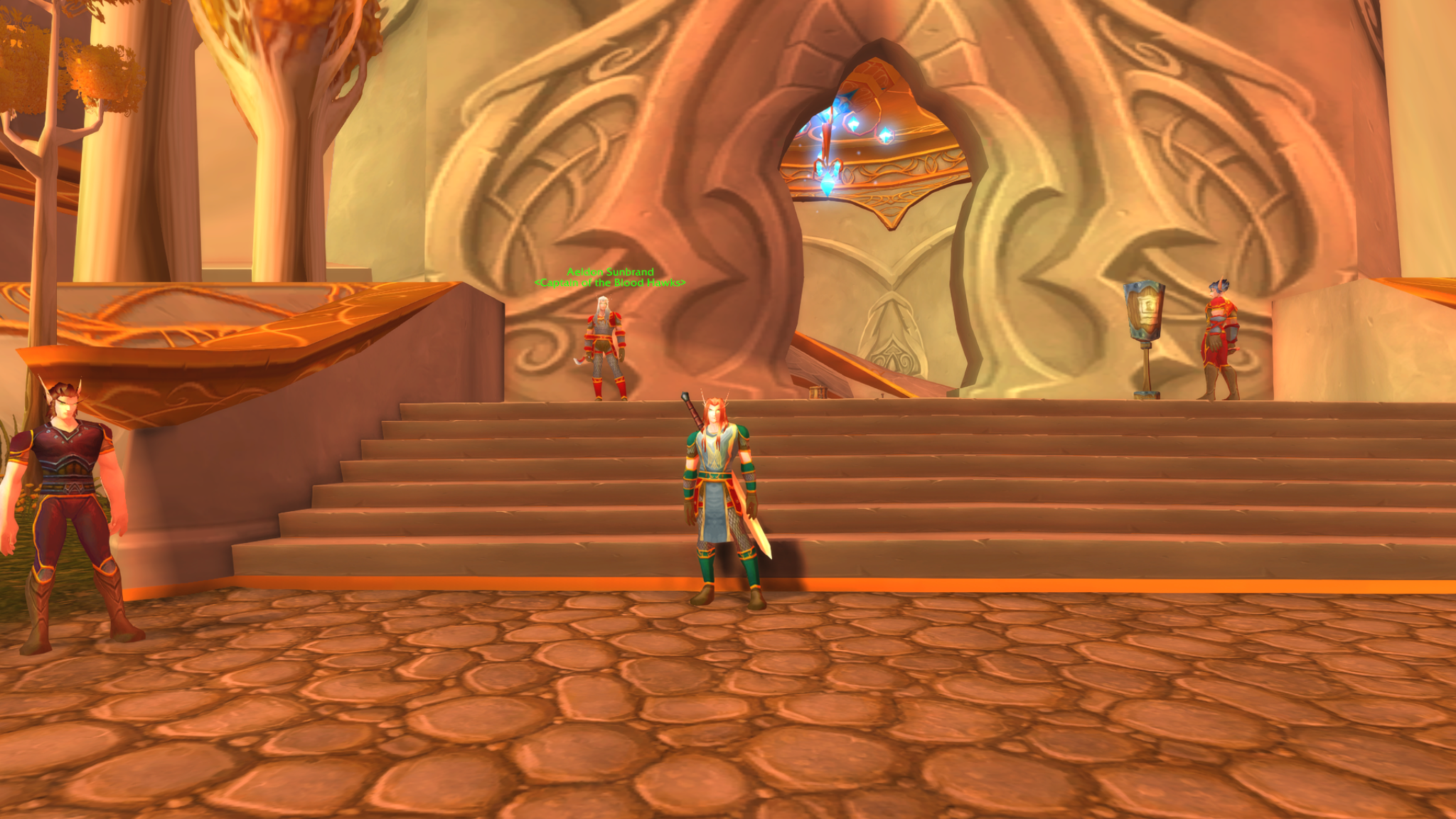 Lïr wearing a tabard on the steps outside a blood elf building, with Aeldon Sunbrand behind him.